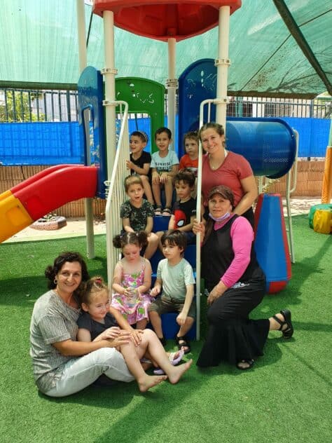 W&J Senior Hailey Nudelman stands in a playground with her students in Israel.