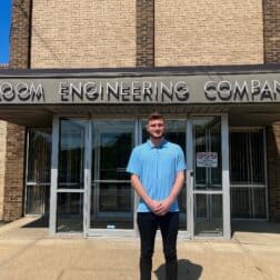 Recent W&J alumnus Alex Donahue stands and smiles outside of Bloom Engineering Company.