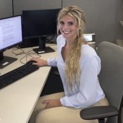 Photo of Arabella Thompson working at a computer during her research internship.