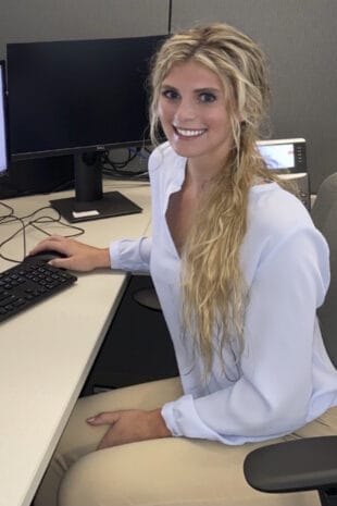 Photo of Arabella Thompson working at a computer during her research internship.