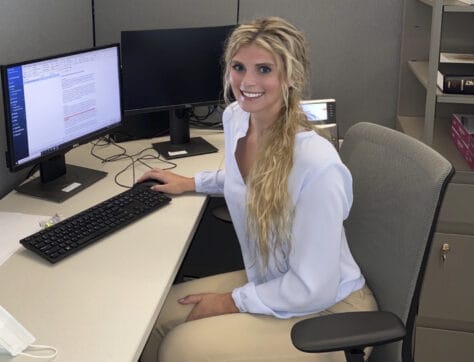 Photo of Arabella Thompson working at a computer during her research internship.