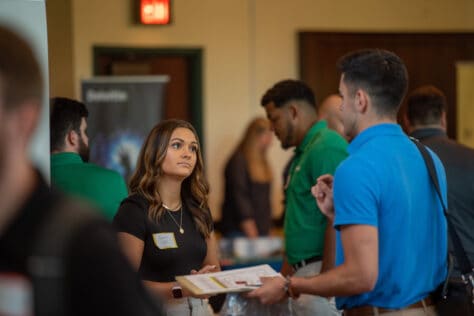 Students and employers talk in Rossin Ballroom during 2022 Career & Internship Fair.