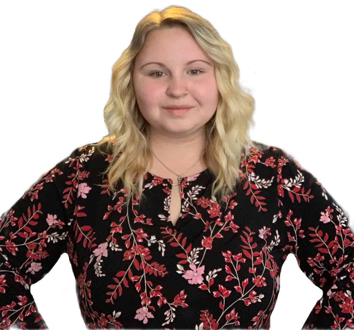 W&J senior Courtney McIntyre stands with her hands on her hips in front of a bright white backdrop.