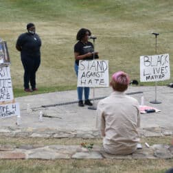 W&J BSU President Tamia Mickens '21 speaks surrounded by signs promoting racial justice at the BSU's Celebration of Black Life, held in the amphitheater on W&J's campus.