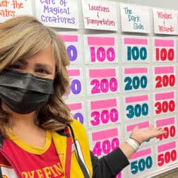 Instructor of Accounting Dana Allen poses with a jeopardy board for contest with her FYS students.