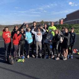 First-year Track & Field and Cross-Country runner, Jacob Davis, stands with teammates who helped pace him to a personal victory.