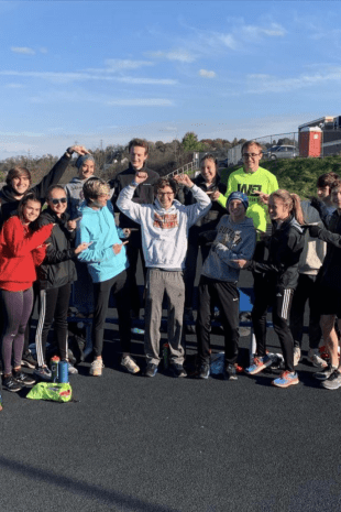 First-year Track & Field and Cross-Country runner, Jacob Davis, stands with teammates who helped pace him to a personal victory.