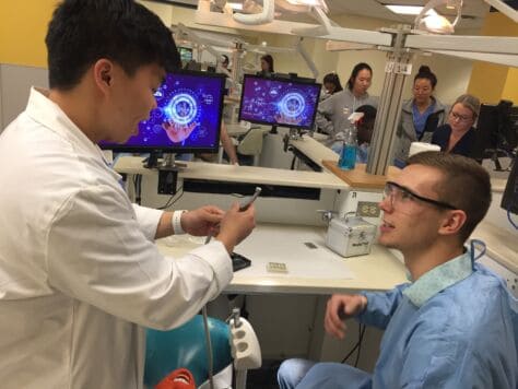 Two students in Ron Bayline's "Persepectives In Medicine" JayTerm course explore a dental lab as part of the class.