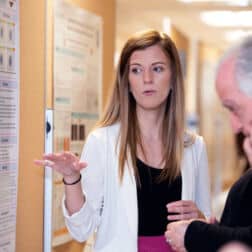 Elisa Yazdani presents her work at a poster session.