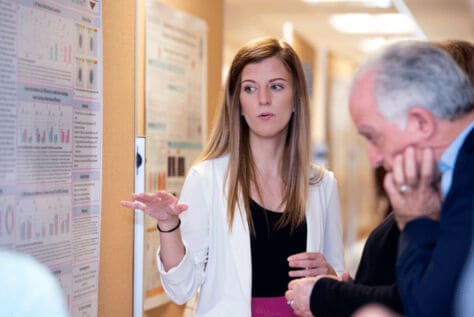 Elisa Yazdani presents her work at a poster session.