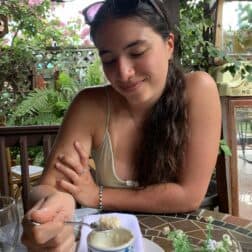 W&J rising senior Isabella Manzari smiles down at a cup of Cuban cuisine.