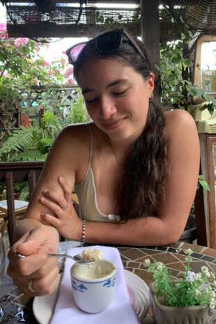 W&J rising senior Isabella Manzari smiles down at a cup of Cuban cuisine.