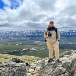 Recent W&J alumnus Jeffrey Seabury, Jr. '22 stands atop a mountain in Alaska during his Magellan Project.