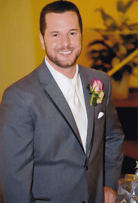 Jonathan Flickinger '05 smiles in a suit.