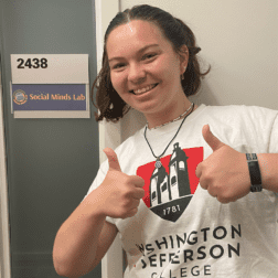 W&J rising senior Julia Hurwitz stands outside of the University of Michigan's Social Minds Lab and gives two thumbs up.