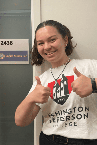 W&J rising senior Julia Hurwitz stands outside of the University of Michigan's Social Minds Lab and gives two thumbs up.