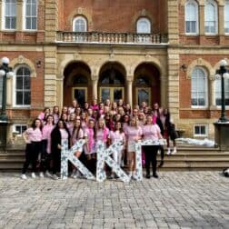 The women of Kappa Kappa Gamma pose in front of Old Main on W&J's campus.