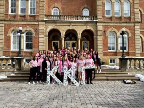 The women of Kappa Kappa Gamma pose in front of Old Main on W&J's campus.