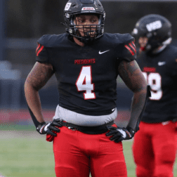 W&J alumnus Keith Knowell '21 stands in uniform on football field.