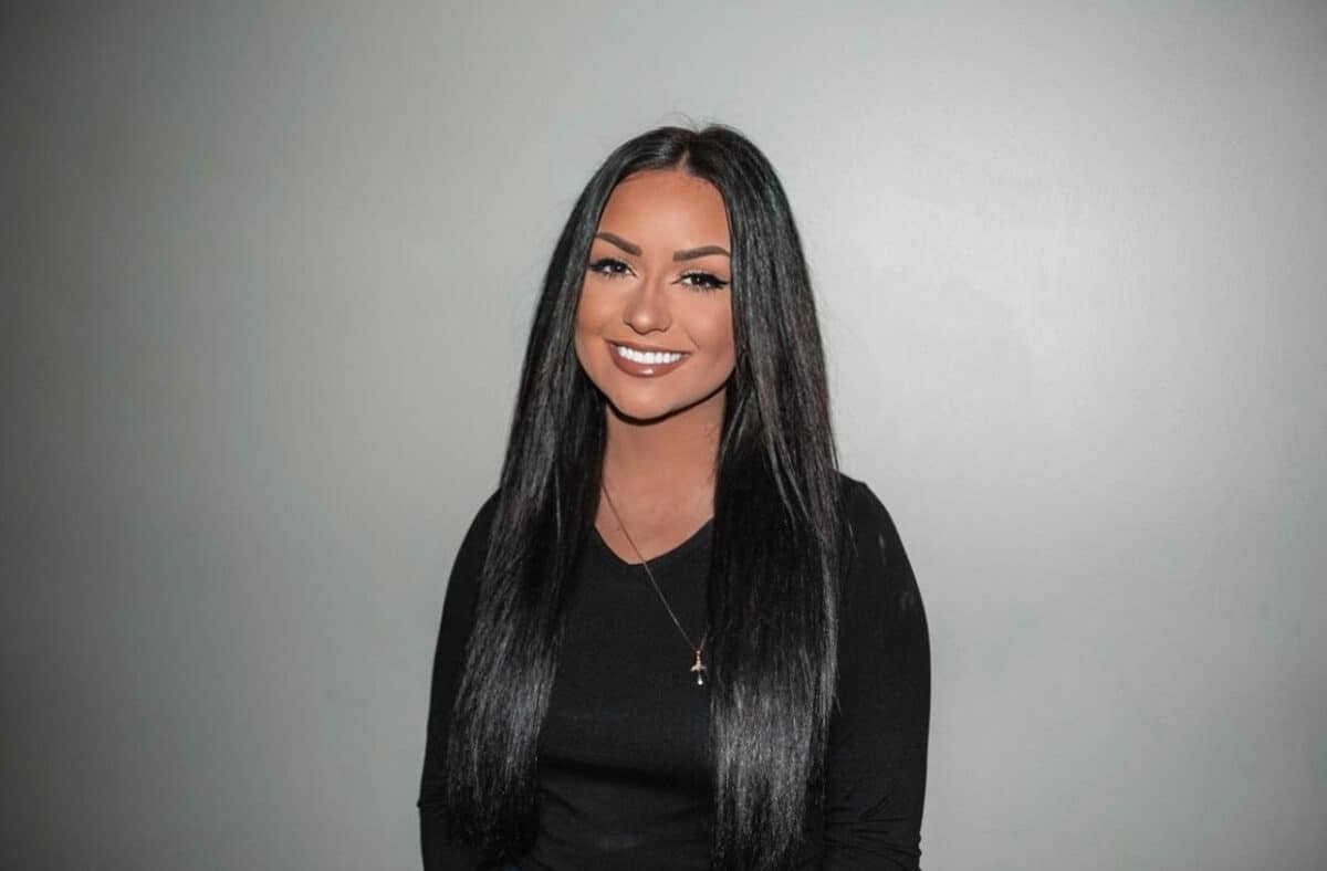 W&J senior Kristine Horissian smiles in front of a gray backdrop.