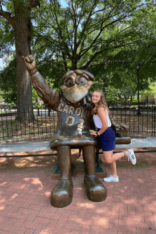 W&J alumna, Ashely Kunkle poses with University of South Carolina mascot statue.