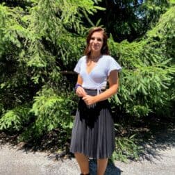 W&J senior Kyleigh Jester stands in front of an evergreen tree and smiles.