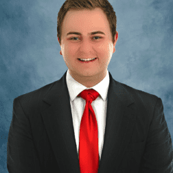 W&J Junior Nick Bartel smiles in a suit.