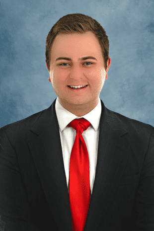 W&J Junior Nick Bartel smiles in a suit.