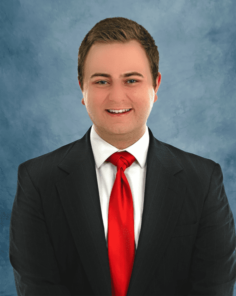 W&J Junior Nick Bartel smiles in a suit.