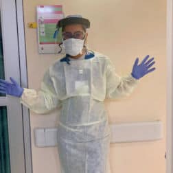 Bianca Pate '22 poses in PPE outside a room at the Latrobe Hospital ICU.