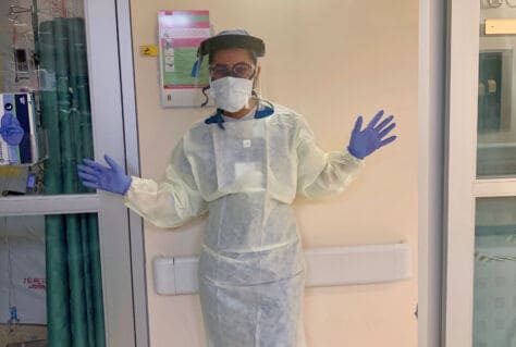 Bianca Pate '22 poses in PPE outside a room at the Latrobe Hospital ICU.