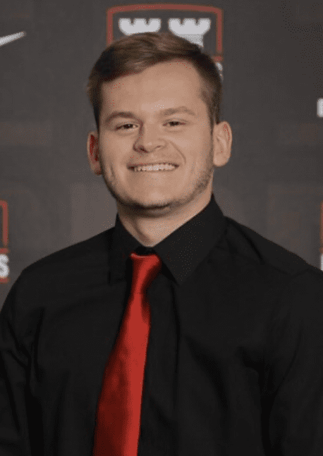 W&J Senior Robert Fleischauer smiles in a black shirt and red tie.