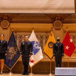 ROTC students from area colleges stand at attention in their commissioning ceremony.