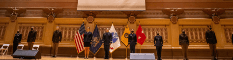 ROTC students from area colleges stand at attention in their commissioning ceremony.