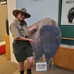 semesters studying in historic structures and cozy W&J senior Stephanie Shugerman poses with cardboard buffalo in park ranger uniform.