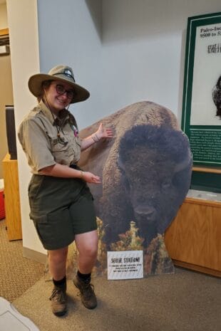 semesters studying in historic structures and cozy W&J senior Stephanie Shugerman poses with cardboard buffalo in park ranger uniform.