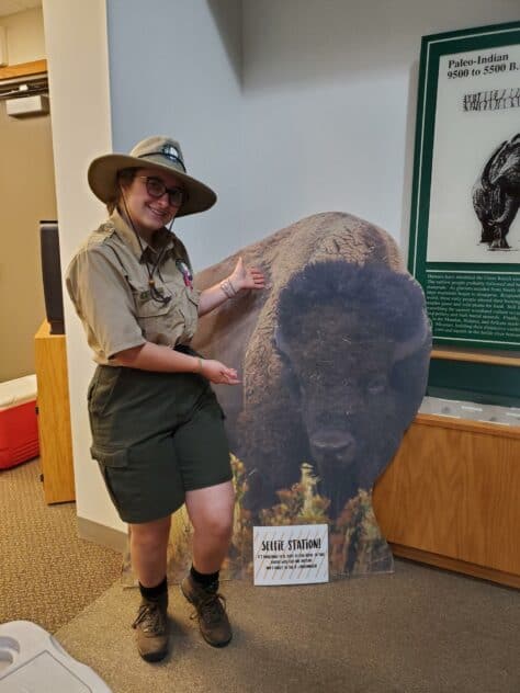 semesters studying in historic structures and cozy W&J senior Stephanie Shugerman poses with cardboard buffalo in park ranger uniform.