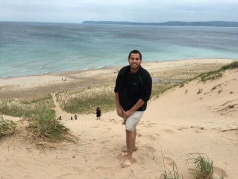 Wes Pein poses on a beach.