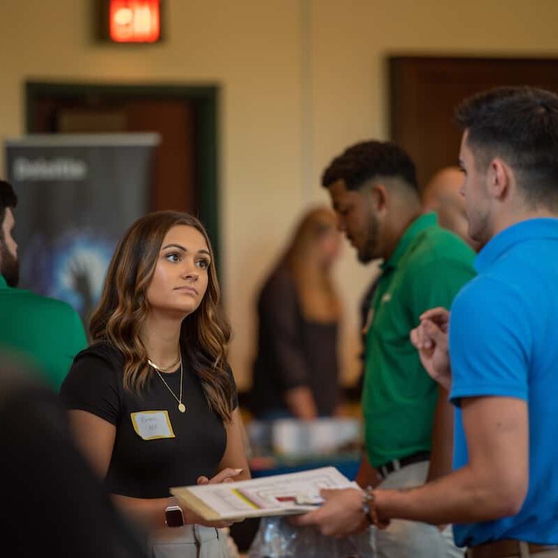 Students and employers talk in Rossin Ballroom during 2022 Career & Internship Fair.