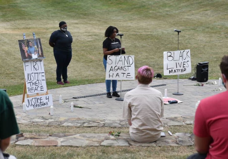 W&J BSU President Tamia Mickens '21 speaks surrounded by signs promoting racial justice at the BSU's Celebration of Black Life, held in the amphitheater on W&J's campus.