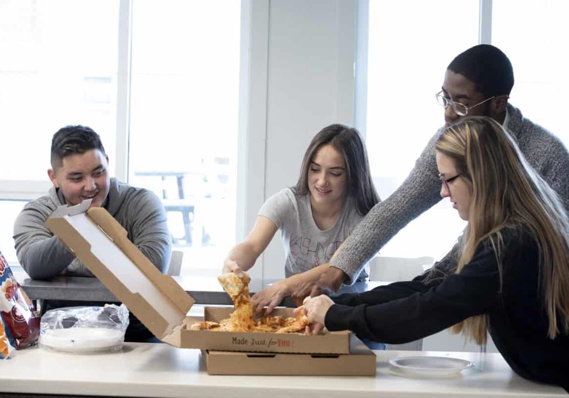 Students hang out, talk, eat pizza, and play games in Beau Hall as part of a photo shoot November 21, 2019 at Washington &amp; Jefferson College.