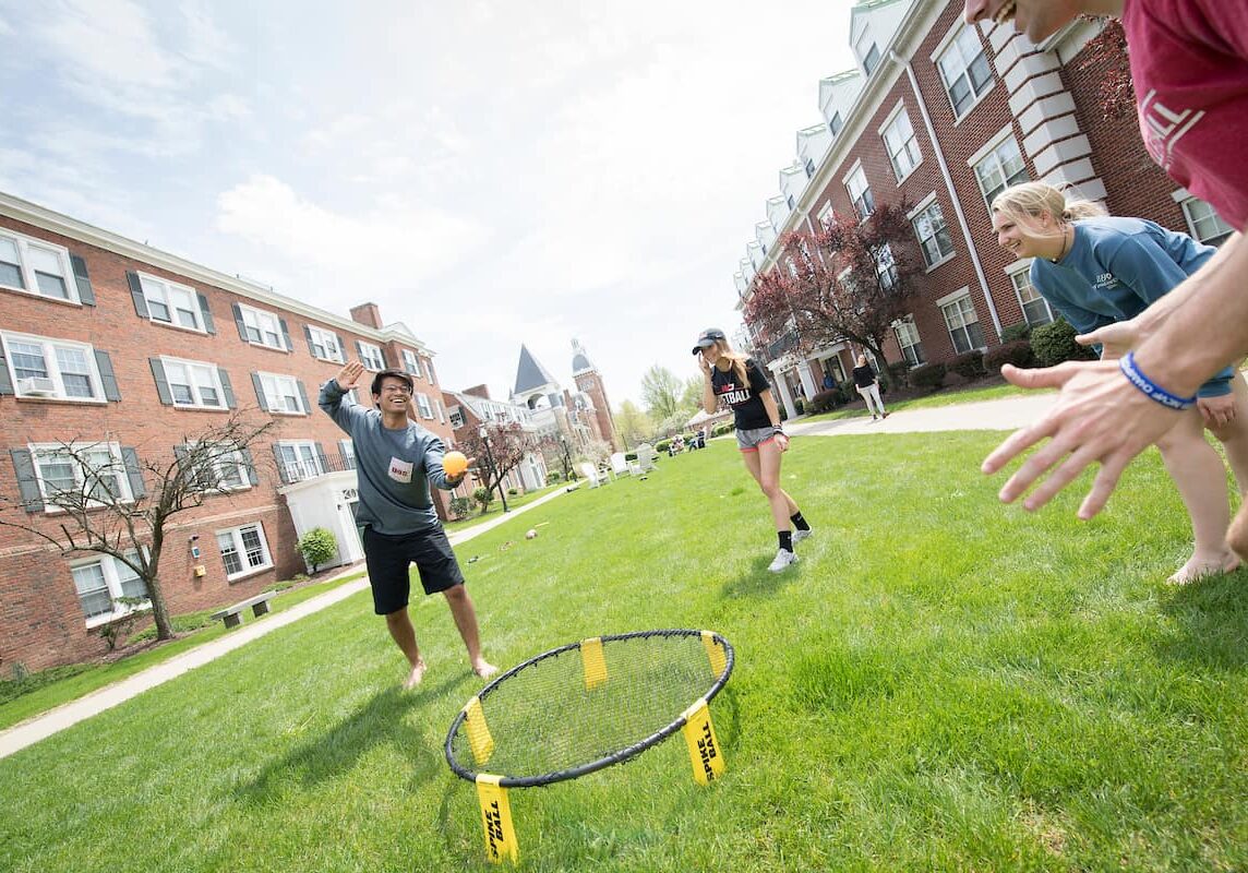 Students playing spike ball outside of Bica-Ross Residence Hall.