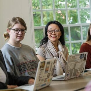 Associate Professor of the English Tara Robbins Fee, Ph.D., works with students.