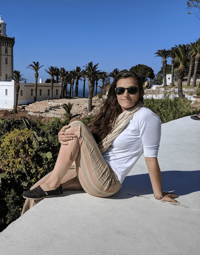 W&J alumna Clara Sherwood poses on a ledge overlooking the sea in Morocco.