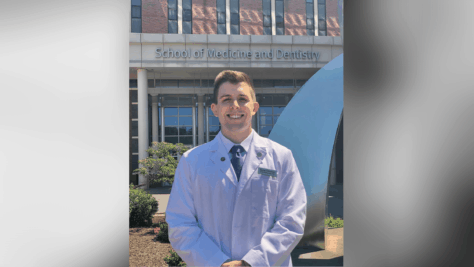 Samuel Florentino standing outside of his medical school