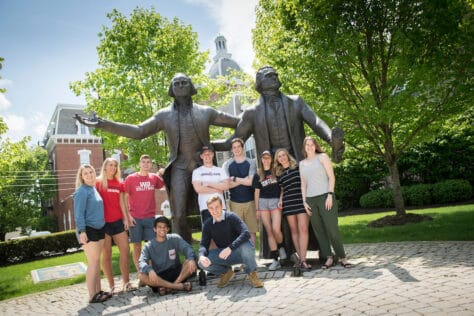 Students pose for pictures with the statues of George Washington and Thomas Jefferson during the Creosote Affects photo shoot May 1, 2019 at Washington & Jefferson College.