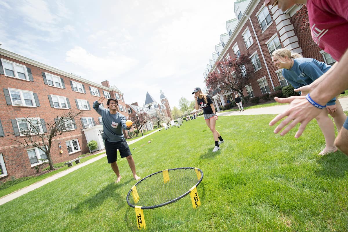 Students playing spike ball outside of Bica-Ross Residence Hall.
