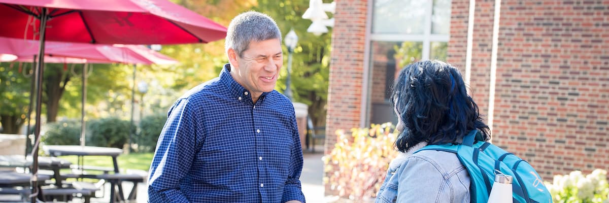 A student talks with faculty member Professor of Chemistry Mark F. Harris, Ph.D., on the Rossin Campus Center Patio as seen October 21, 2019 during the Creosote Affects photo shoot at Washington &amp; Jefferson College.