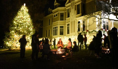 Students gather outside of the President's House during the annual tree lighting ceremony at Washington & Jefferson College.