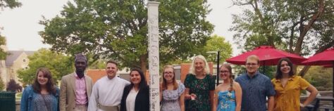 Students in the Interfaith Leadership Club Pose with a Peace Pole.